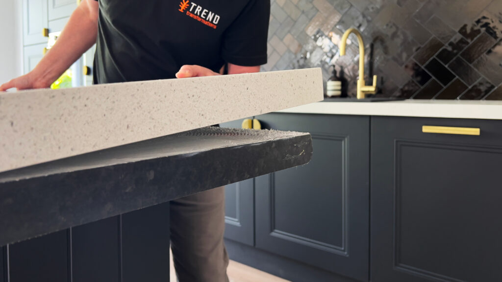 man fitting granite overlay