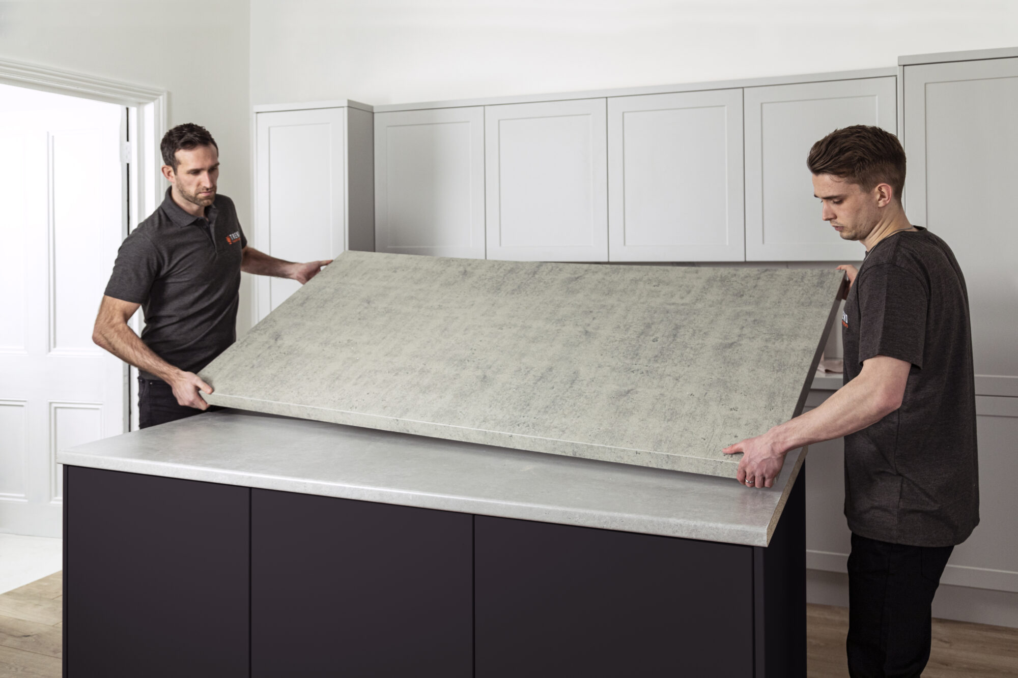 people fitting a granite overlay